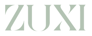ZUXI "Pack With Purpose" wordmark logo in sage green on a transparent background.